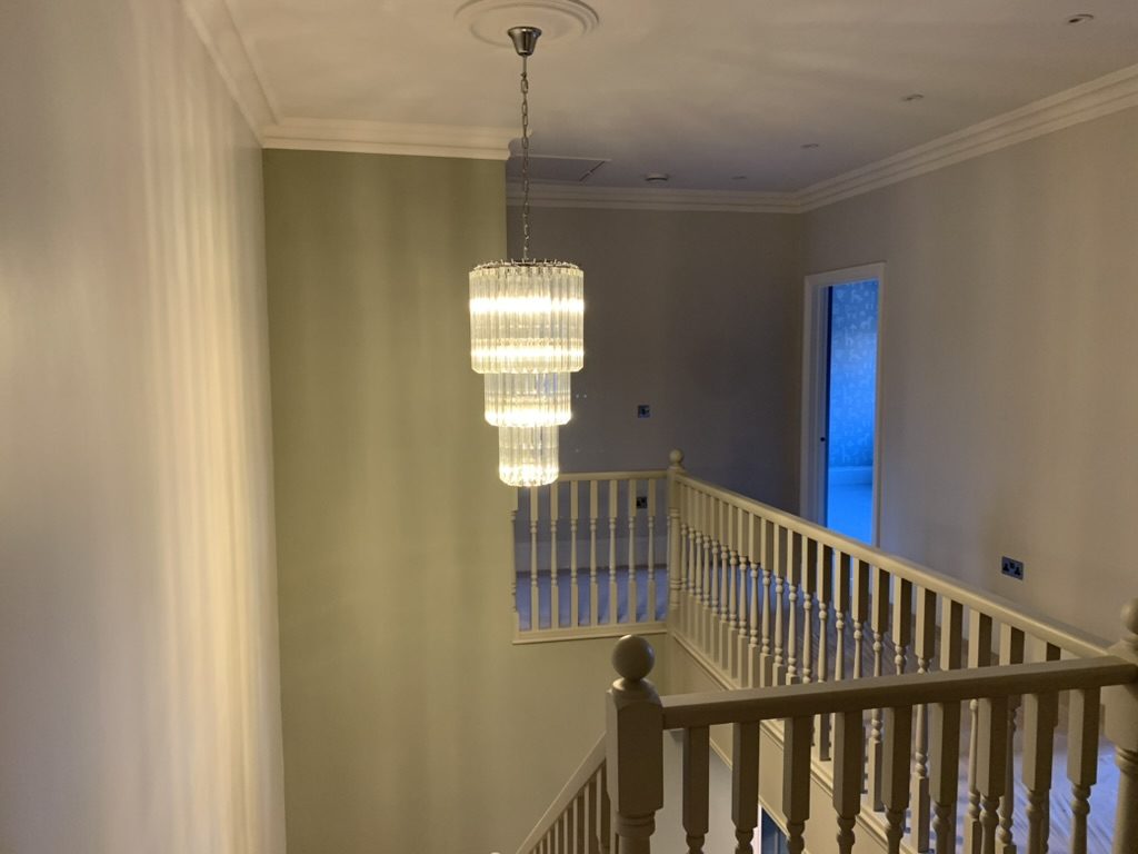 Fixed to a proper load-bearing point rather than a ceiling rose, drop height set from the floor below, and switched from both landings.